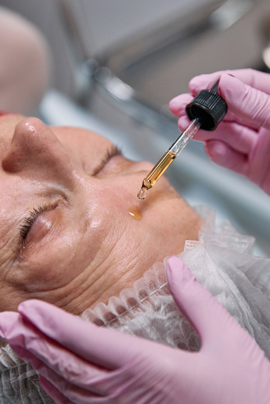 person putting makeup on womans face